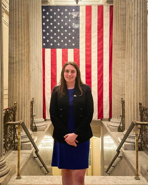 person standing with American flag in background