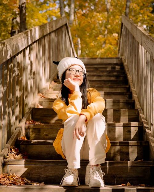 person sitting on steps in fall