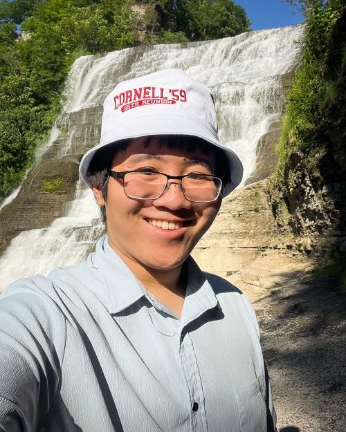 person standing by a waterfall