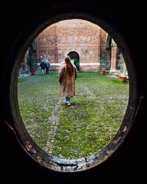 person viewed through hole in a wall