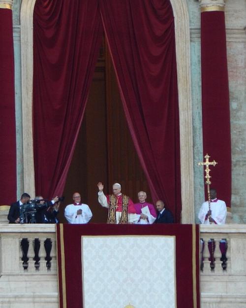 People in religious robes on a balcony