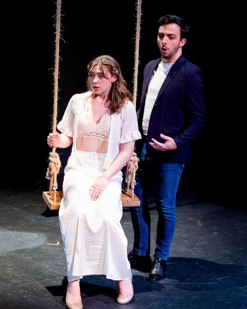 person on a swing on stage