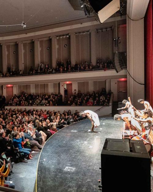 people on a stage taking a bow