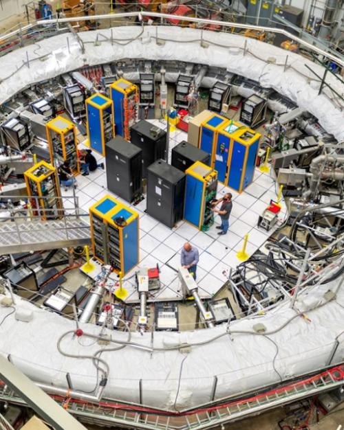 A huge ring with electronic wiring going into the center, along with a ladder-like stairs.