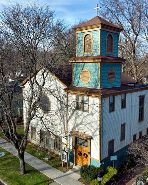 church building with a green-blue bell tower