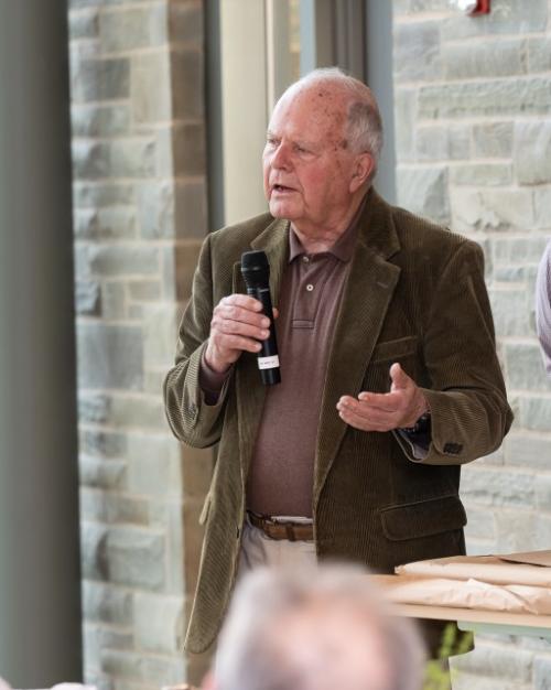 Person speaks, holding a microphone