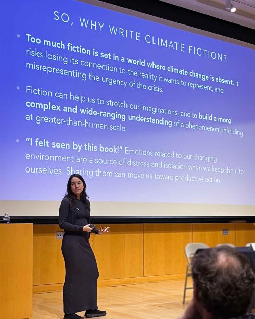 person speaking in front of a PowerPoint