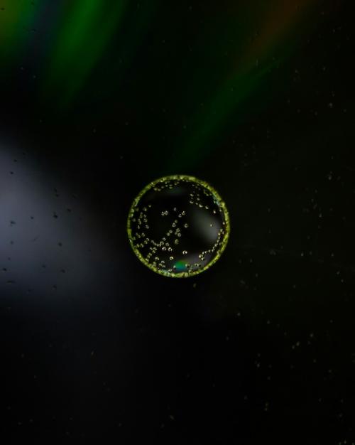 Round formation (a cell), luminescent against a dark background