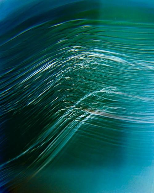 Abstract image in blue and green with lines running in parallel