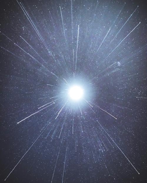 White spark of light against a blue-black background