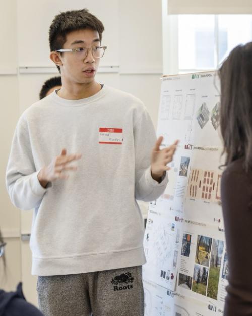 People giving a presentation with a poster