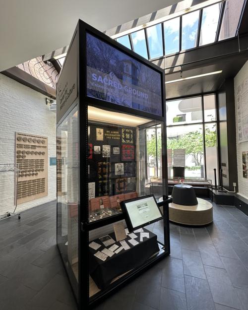 		Tall display case in a museum room that's full of light
	