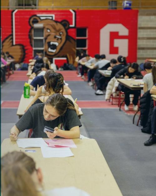 promotional image showing three faculty head shots and a picture of students taking an exam in a very large hall