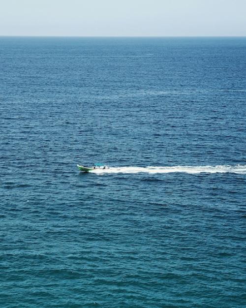 small boat traveling over open water