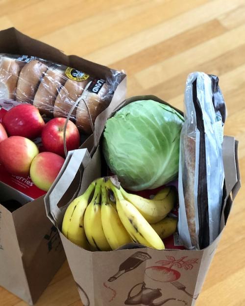 two brown paper bags full of groceries