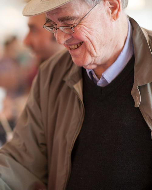 Person smiling down at a cup of ice cream