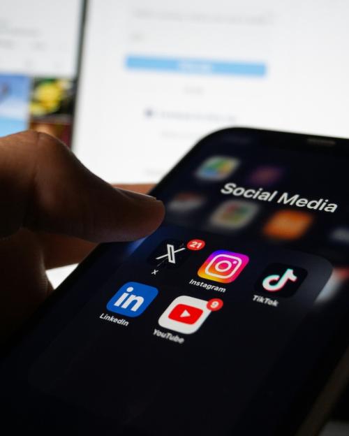 phone with dark mode screen and social media icons