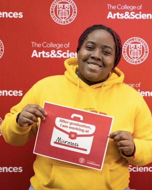 person holding sign saying they are working for Microsoft