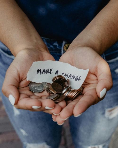 Open hands holding change