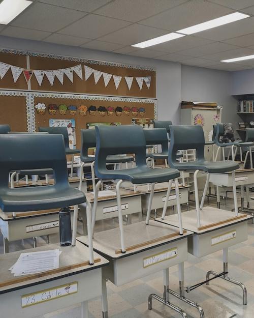 		A classroom empty of students; the chairs are on desks
	