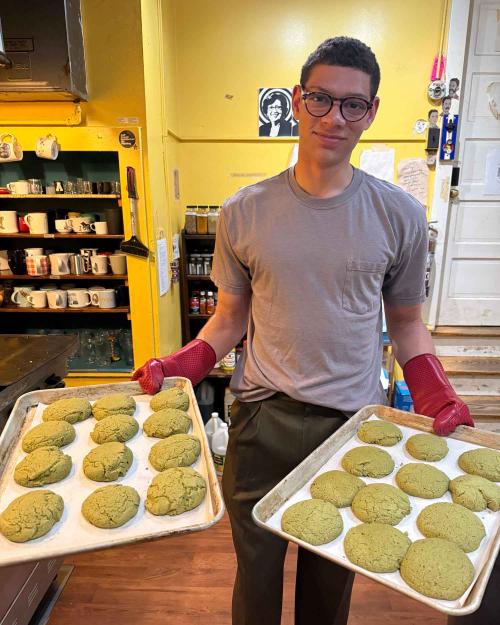 person holding trays of cookies