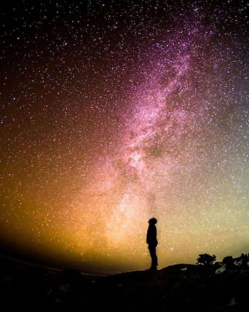 Person looking at a sky full of stars and color