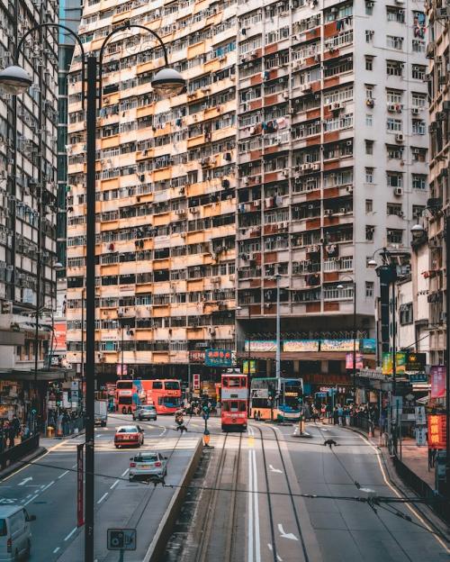 		High rise apartment building fronting a city street with a trolley
	