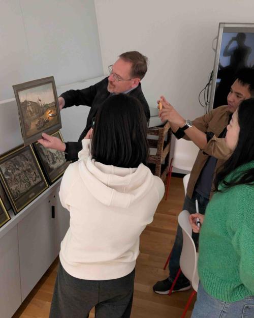 people standing around a portrait