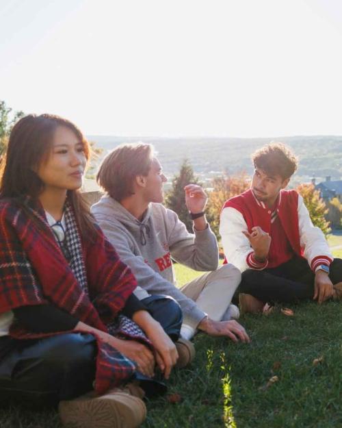 people sitting in a circle on the grass
