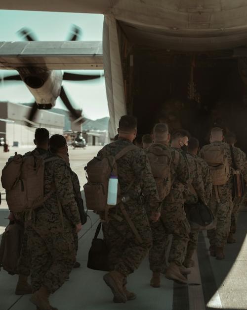 U.S. marines and sailors loading into an aircraft