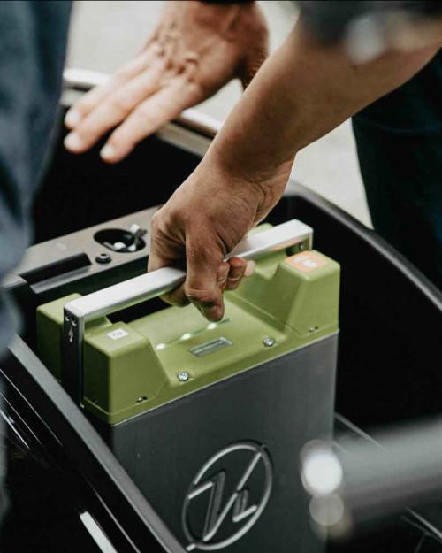 person taking out an electric car battery