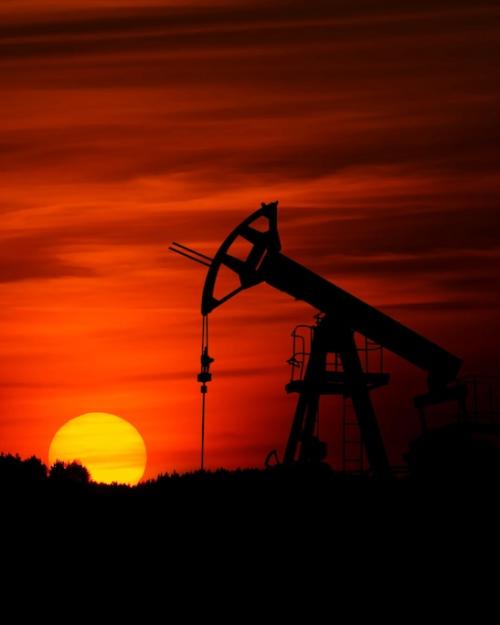 Sunset with a pump mining crude oil