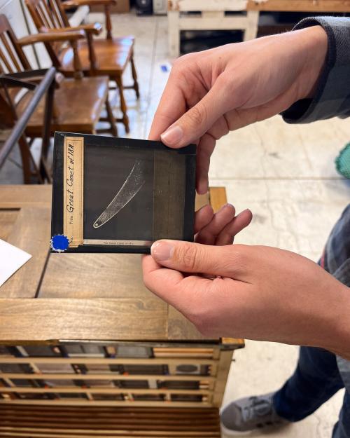 person holding a lantern slide