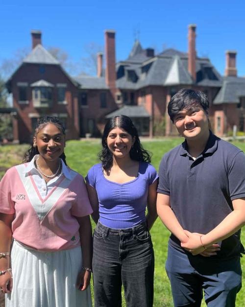 three people standing outside