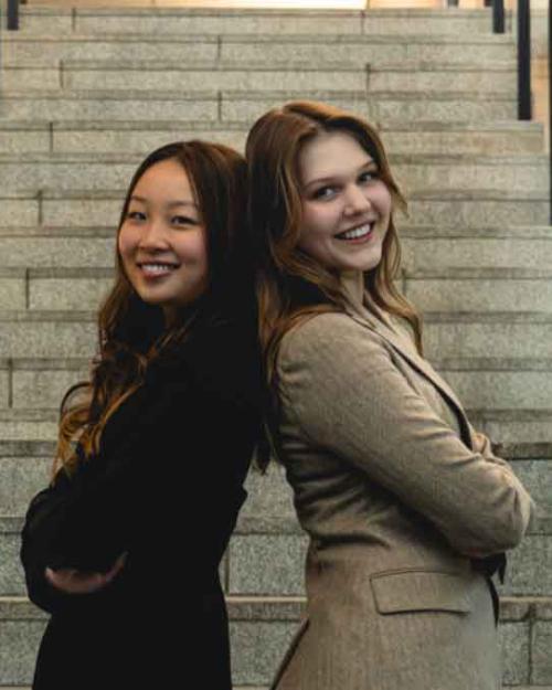 two people in front of a set of stairs