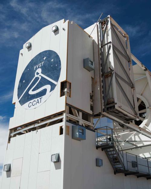 The telescope, a large white structure with the logo on the front, rises three stories in the air.