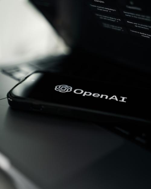Dark phone screen shows a white OpenAI logo