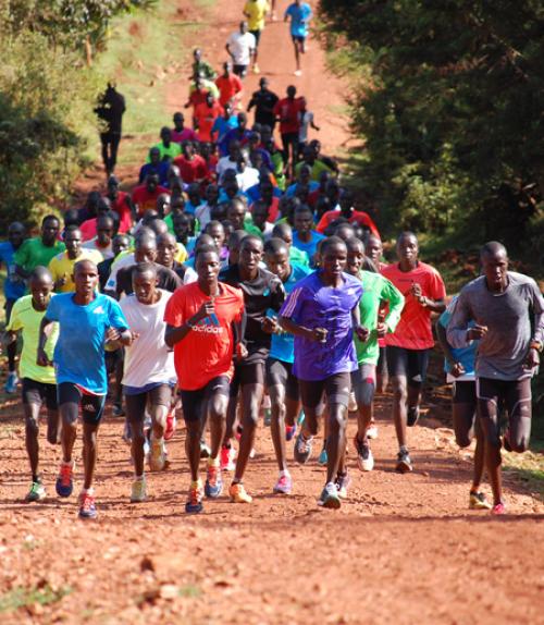  Teenagers running on road in Kenya