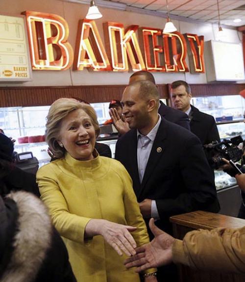  Hillary Clinton shaking hands in bakery