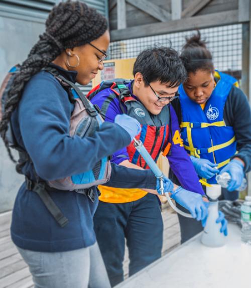  Students from Loughlin Memorial High School in New York City sample water from the Hudson River to help identify invasive species for the FishTracker program.