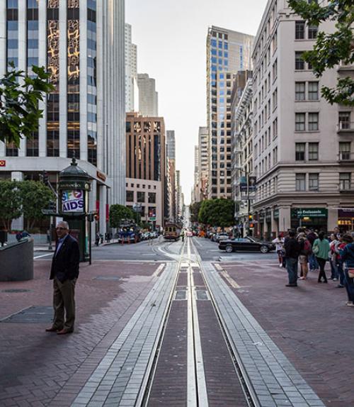  Street scene in San Francisco; tall buildings and cable car track