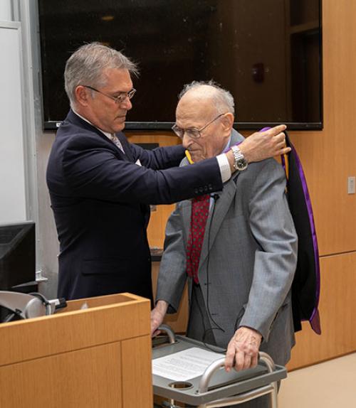  Vincent Boudreau Ph.D. ‘91, president of CCNY, putting the hood on Harold Scheraga for the degree Doctor of Science honoris causa,