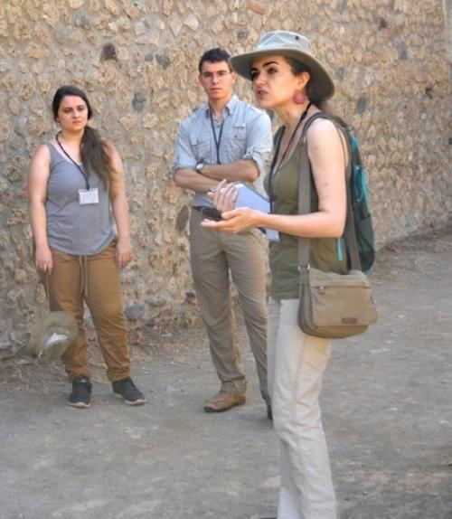  Associate professor Caitlín Barrett takes the Casa della Regina Carolina Project group on a tour of Pompeii.  