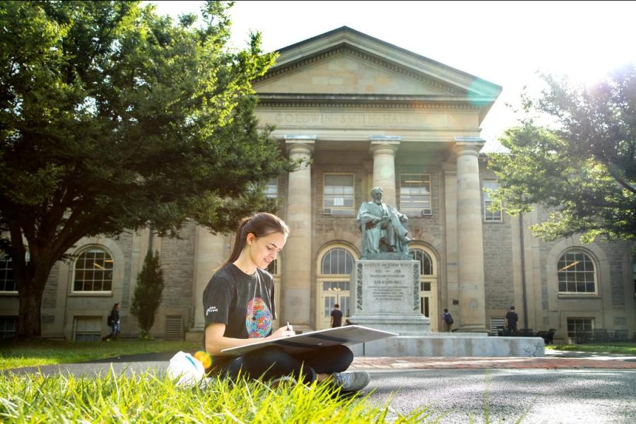 Woman sketching in front of Goldwin Smith Hall