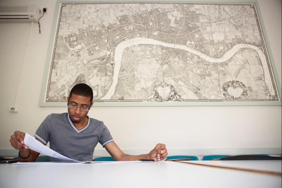 Student studying in front of a map