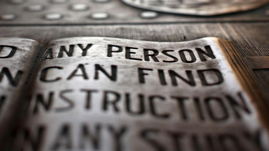 Close-up of a plaque engraved with the Cornell University motto.