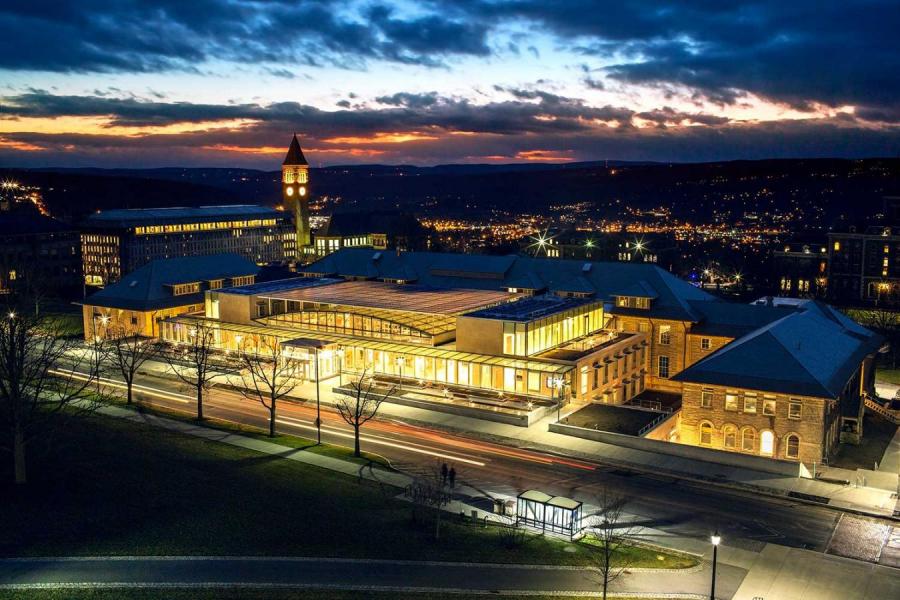 Modern building lit up at dusk, seen from above