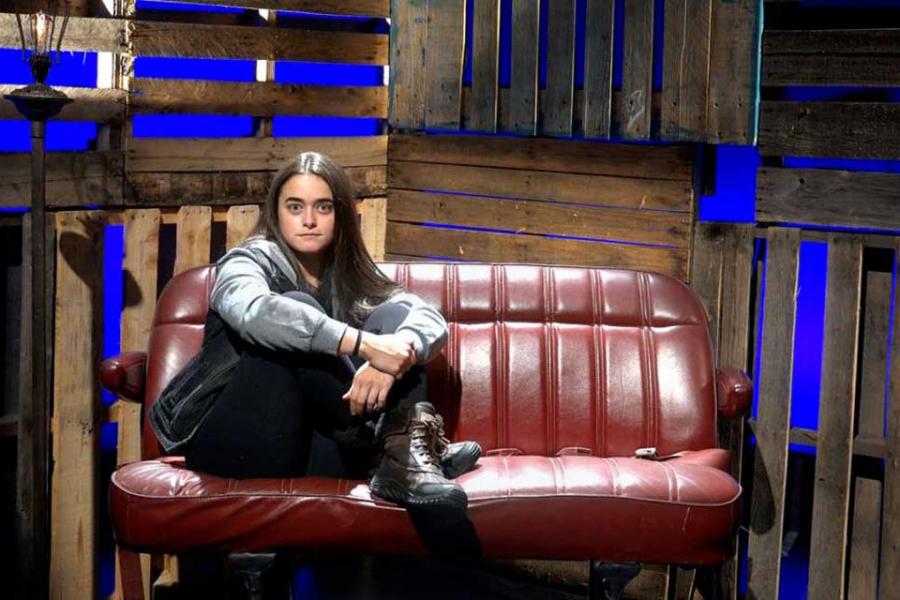 Person sitting on a car seat on a stage set