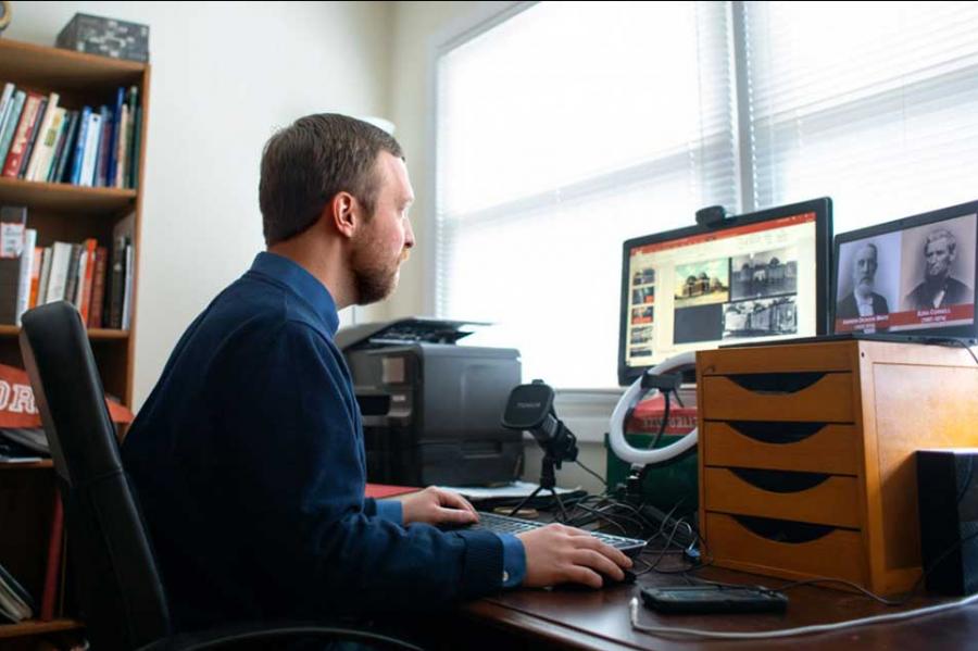 Person sitting at a desk with a computer