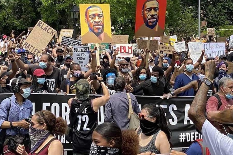 Crowd of people holding signs during BLM protest